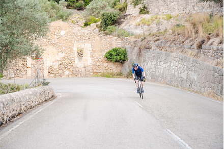 Senior cyclist riding up a mountain, a Sports & Recreation Photo by Xavi Bosch Stock