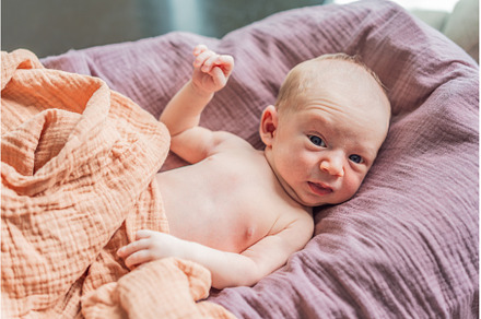 A newborn lies in his cozy cocoon on, a Person Photo by Elizaveta Galitskaya