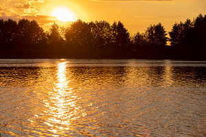 sky reflected in the water during sunset on a lake, a lake with water colored i, a Photo by rsoollAI