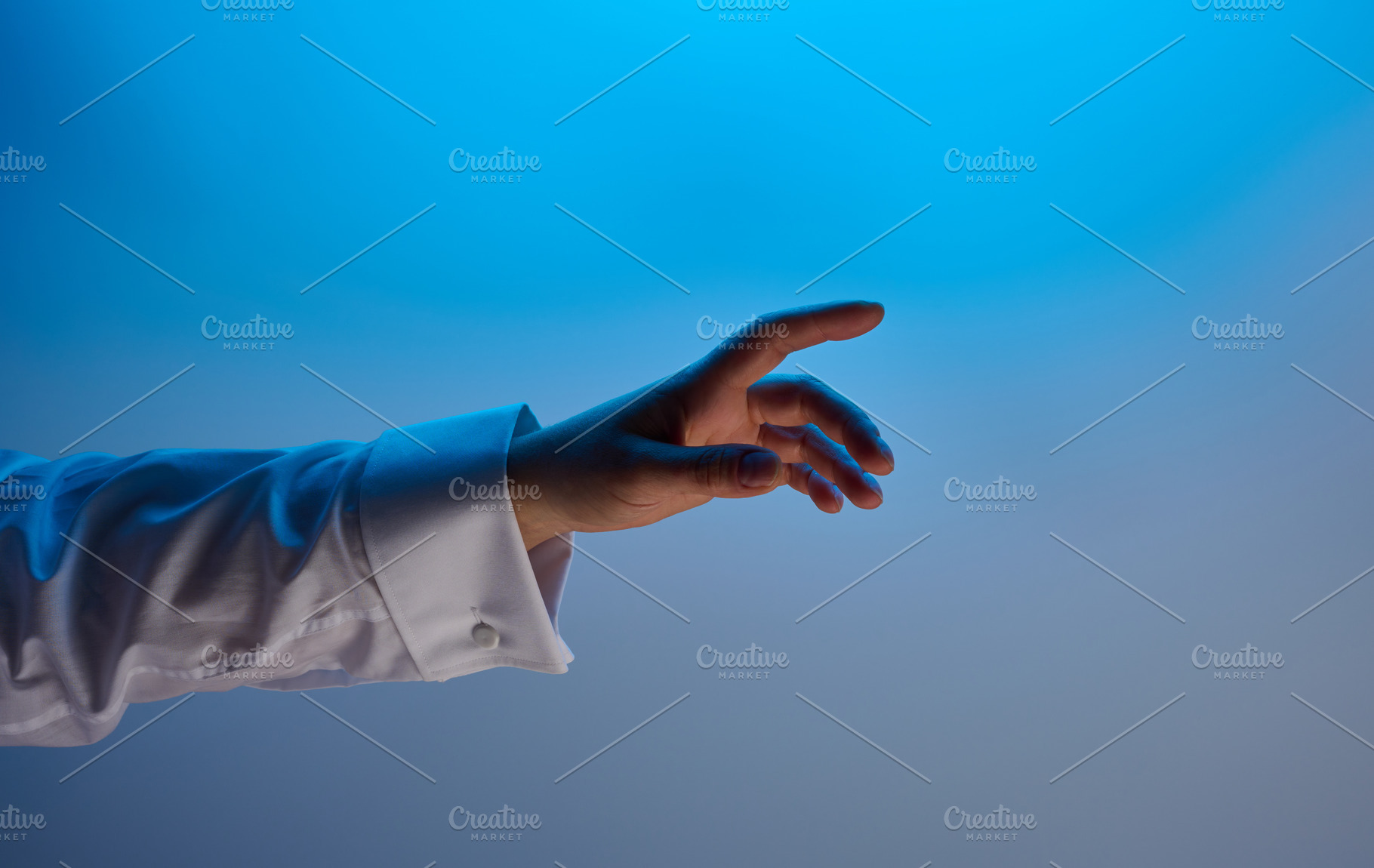 A hand in a white shirt on a blue gradient background, symbolizi, a Person Photo by ndanko