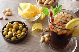 Refreshing cola drink and snack containers on a wooden, a Food & Drink Photo by Davizro's Market