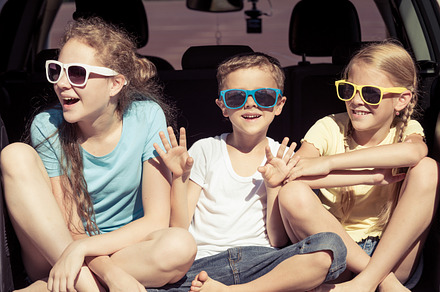 Happy kids sitting in the car containing car, child, and family