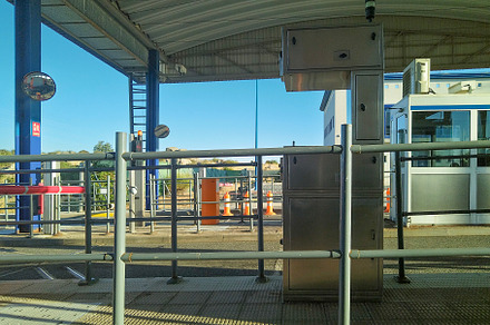Empty toll booth station under metal canopy