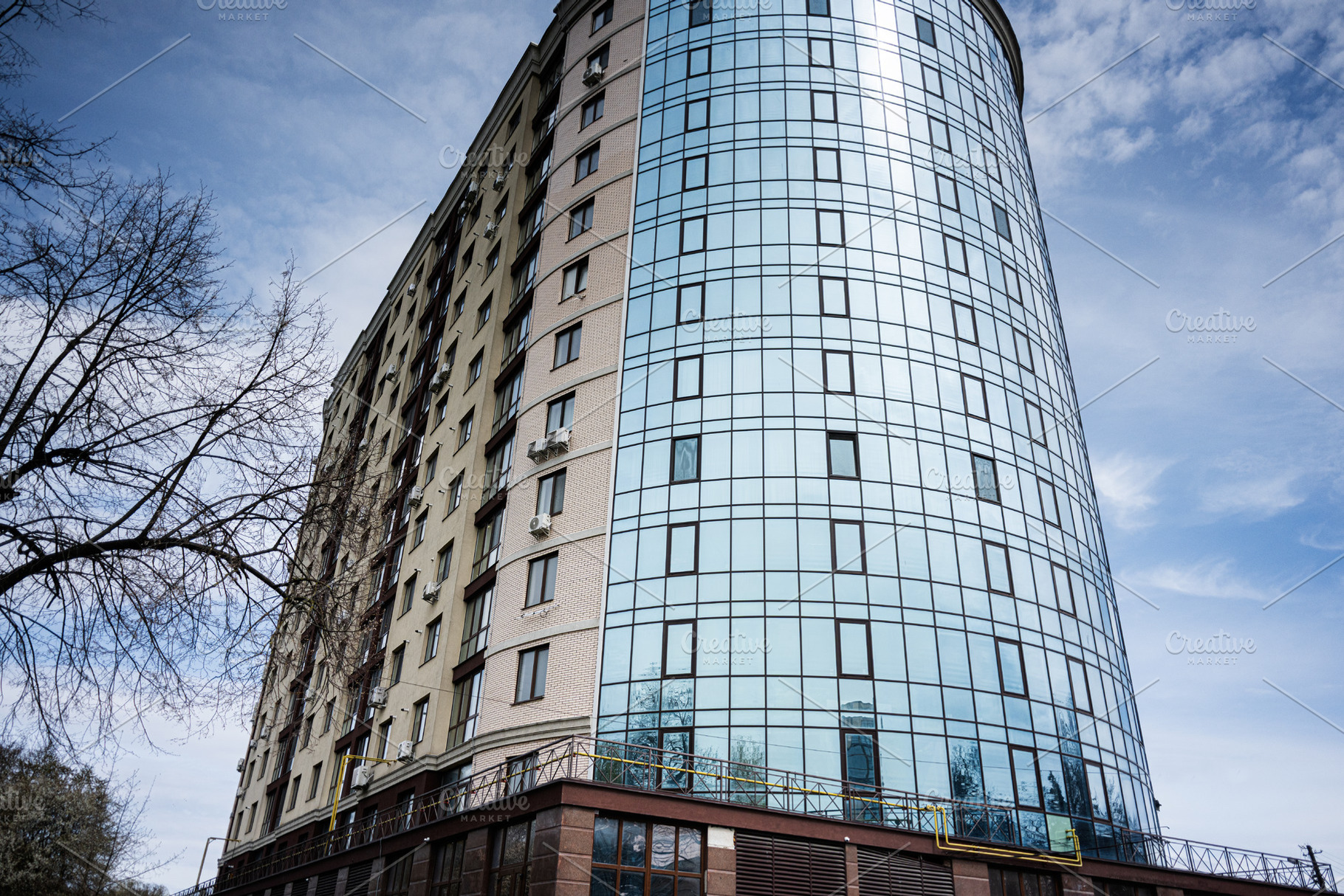 Modern glass and brick high rise building under a clear blue sky, a Photo by AS photostudio