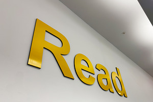 Read sign on a yellow wall in Liverpool, UK modern typography and interior sign, a Photo by AS photostudio