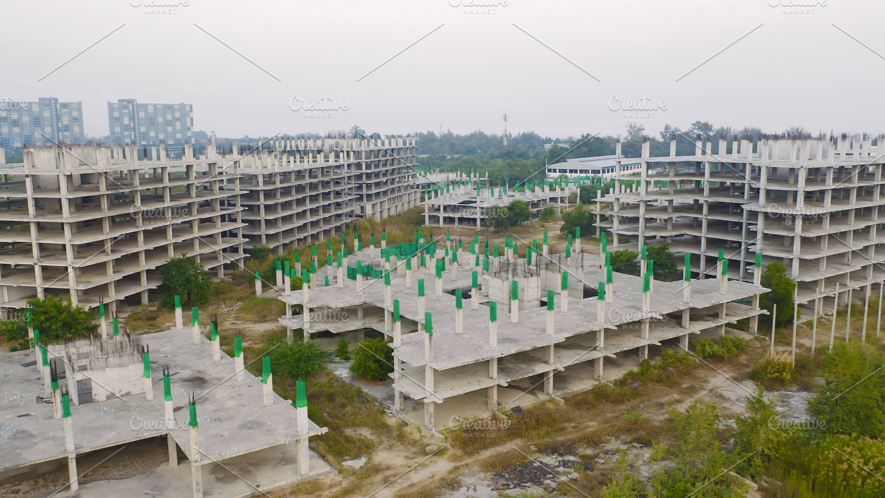 Aerial top view of abandoned apartment or hotel under constructi, a Photo by Tampatra