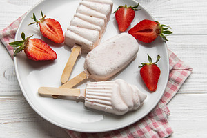 Homemade strawberry ice cream popsicles with fresh fruit, a Food & Drink Photo by Olena Rudo