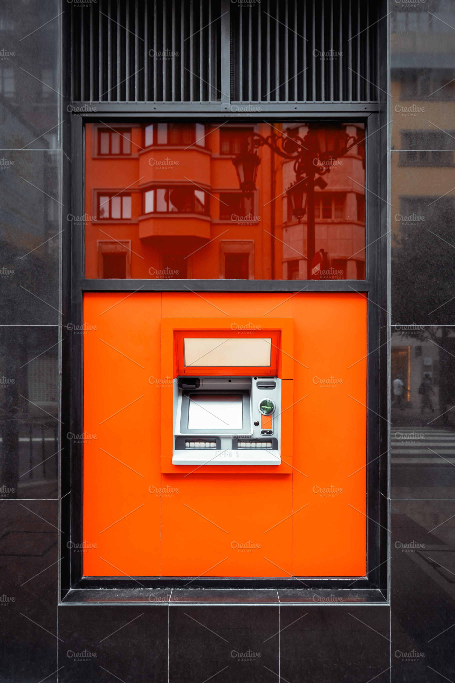Modern ATM in orange wall panel, a Business Photo by SkyNext