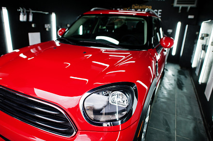 Headlights and hood of sport red car in garage., a Transportation Photo by AS photostudio