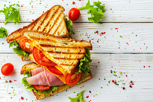 Toast sandwich with cheese, turkey ham, tomato and fresh lettuce on wooden tabl, a Food & Drink Photo by AlyaAnd