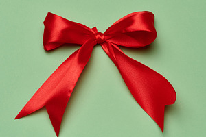 A lush red satin bow made from a wide ribbon in the center of th, a Holiday Photo by ndanko