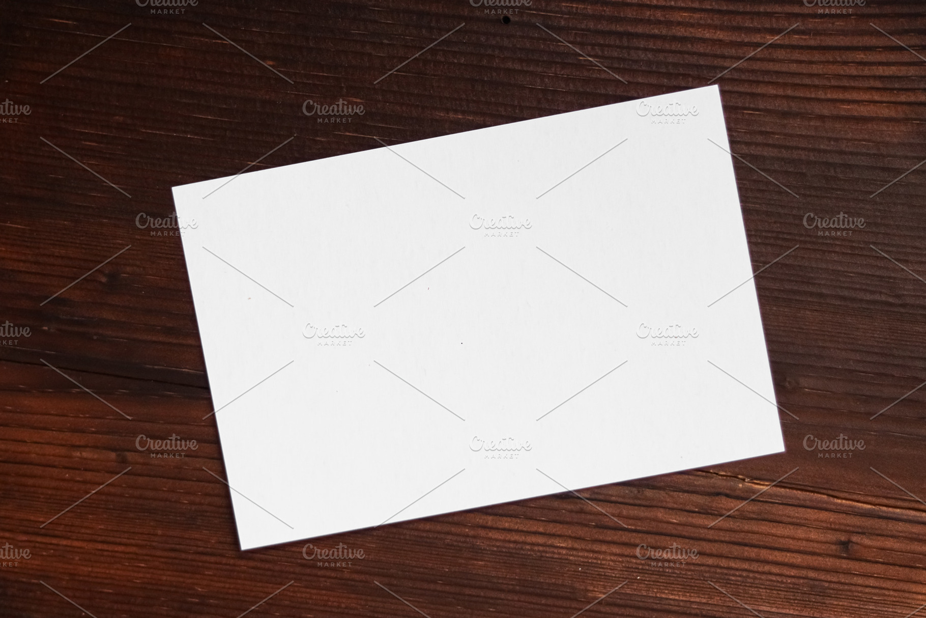 Blank white paper card on a rustic wooden table, providing copy space for text, a Photo by Studio ANNA