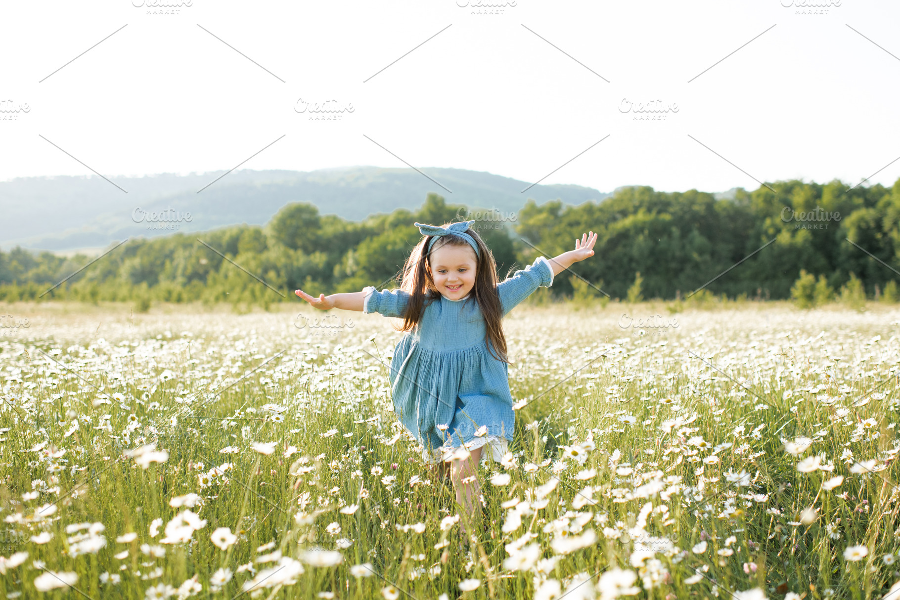 Cute child girl in flowers field, a Person Photo by morrowlight