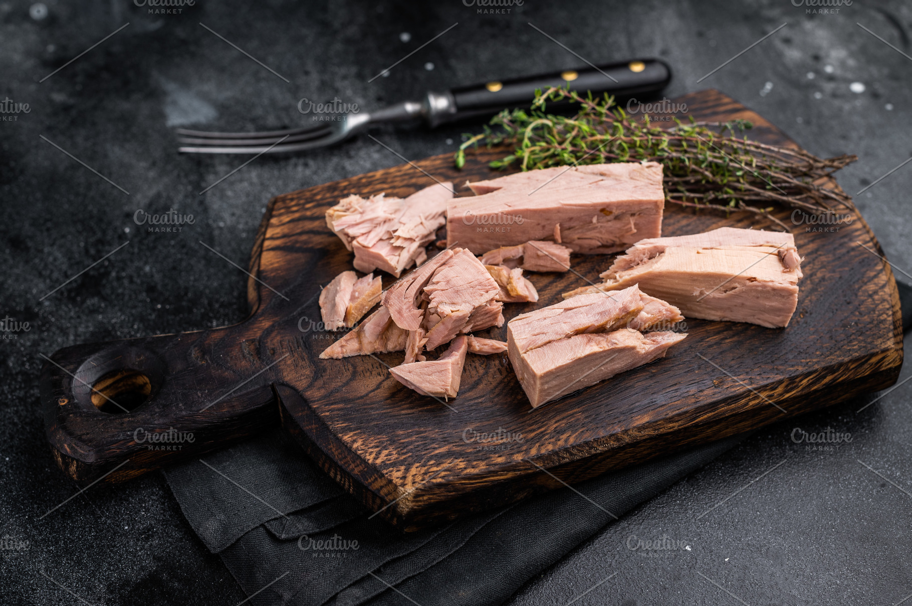 Chunky tinned tuna served on a wooden board, perfect for meal pr, a Food & Drink Photo by composter-box@mail.ru