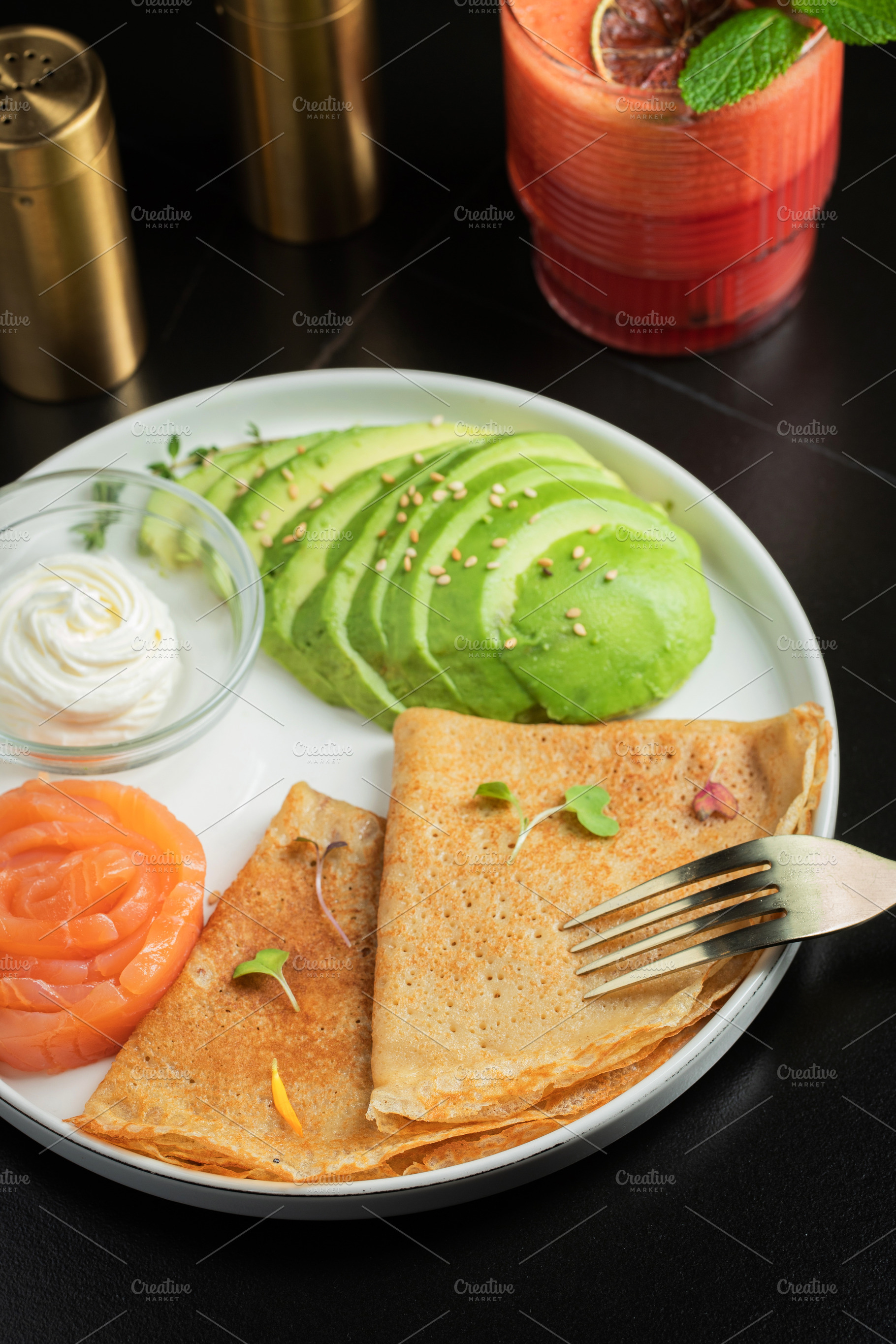 Roasted thin pancakes with smoked salmon and sauce, a Food & Drink Photo by Budarinphoto