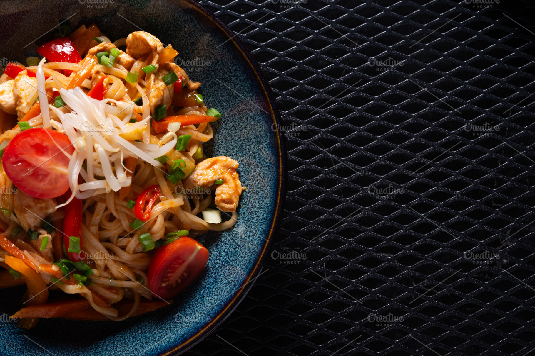 Noodles with Chicken and Vegetables on Dark Plate with Copy Spac, a Photo by MDBildes