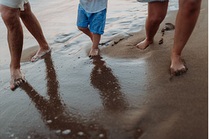 Legs and feet of family standing on, a Person Photo by HalfPoint