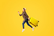 Female Tourist Running In Mid Air Carrying Suitcase, Yellow Background, a Photo by Prostock-Studio (Thumbnail 1 of 2)