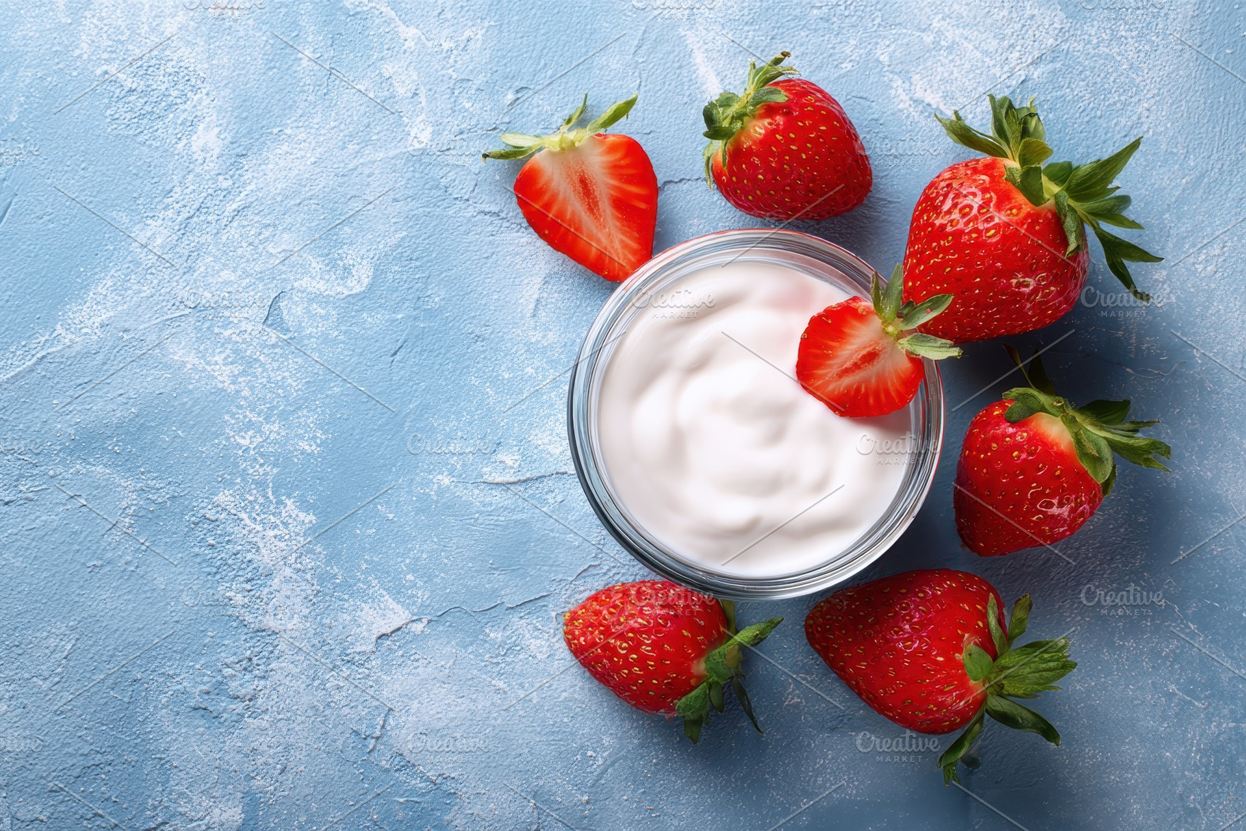 Fresh strawberries surround a bowl, a Photo by Pavel_design