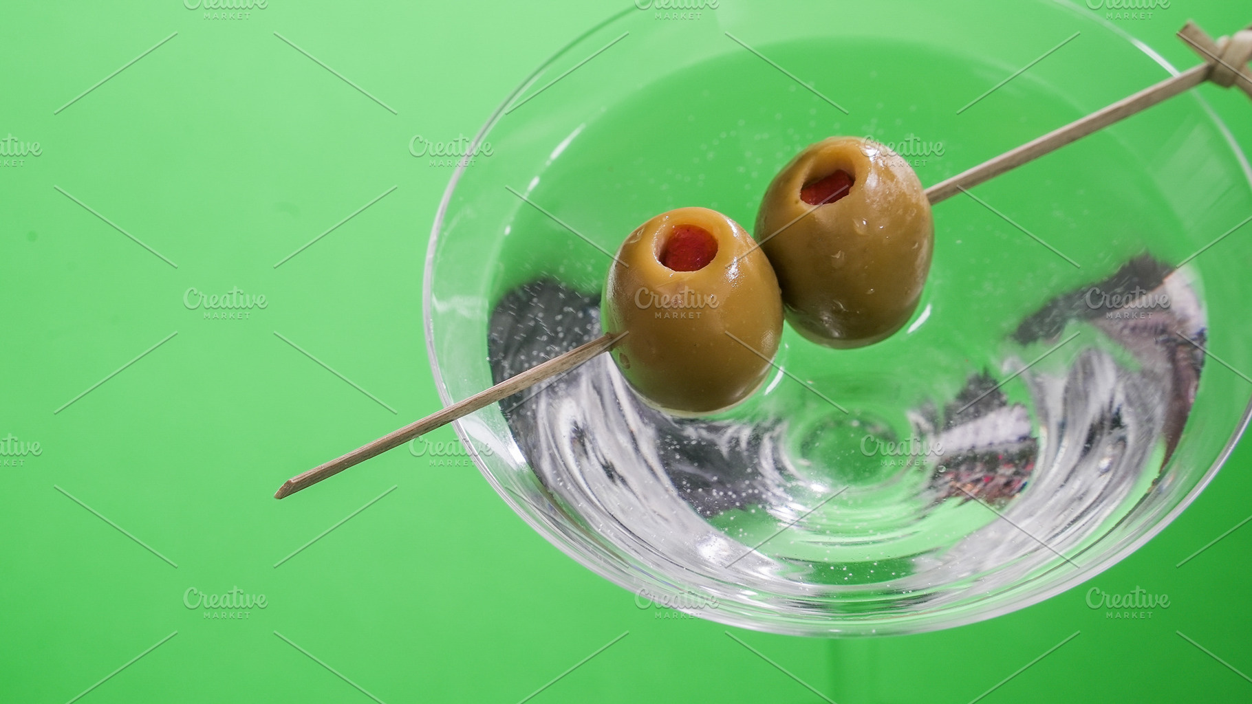 Skewered two olives in a glass with, a Food & Drink Photo by 1miromiro