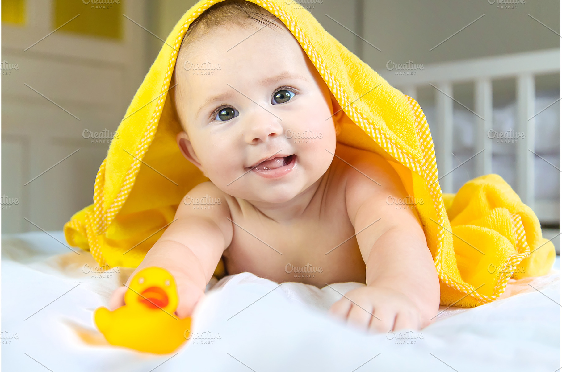 Baby after bathing in a towel, a Person Photo by yanadjana