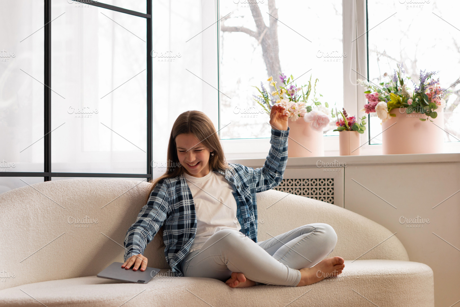 Smiling teen girl playfully placing, a Person Photo by Elena Vagengeim