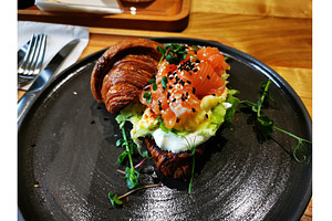 Croissant with salmon, egg, a Food & Drink Photo by sceptical cactus