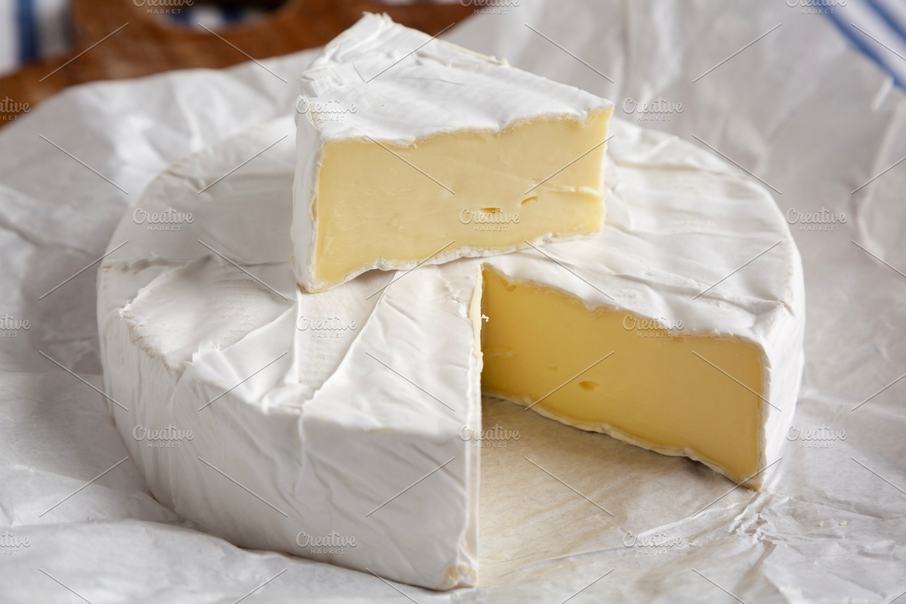 Homemade White Brie Cheese on a Wooden Board, side view. Close-u, a Food & Drink Photo by LiudmylaChuhunova
