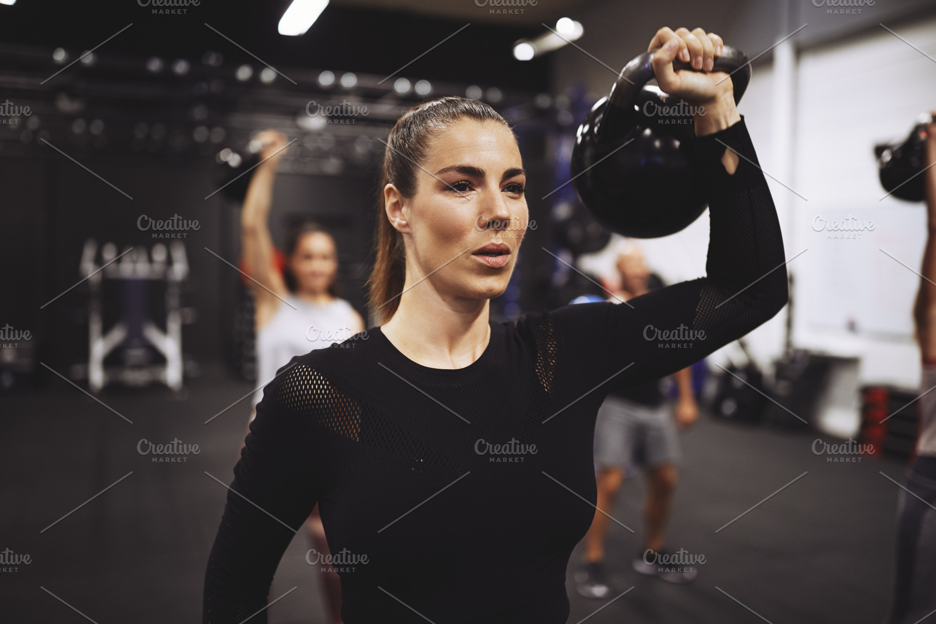 Young woman working out with weights in a gym class, a Sports & Recreation Photo by Stefan & Janni