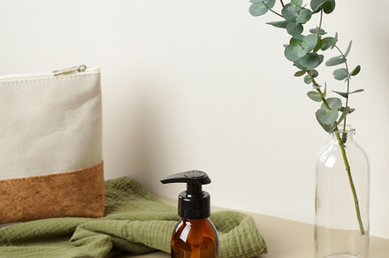 Amber glass dispenser bottle on wooden stand. Soap liquid, shampoo or shower ge, a Health & Medical Photo by photoguns