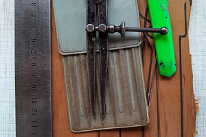 Collection of tools on a wooden surface with drawn outlines, a Sports & Recreation Photo by DanFLCreativo