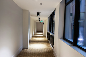 Bright modern hallway with large windows and tiled floor in a quiet office buil, a Photo by AS photostudio