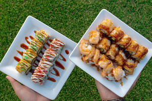 Sushi rolls on plates held in hands, a Photo by Beautiful things