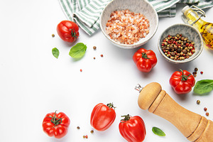 Fresh cooking ingredients with tomatoes, basil, pepper, and salt, a Photo by Olena Rudo