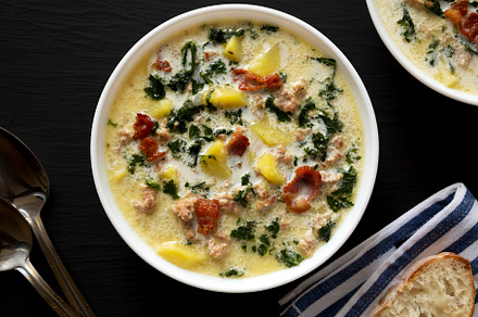 Homemade Zuppa Toscana with Kale and Bread in a white bowl on a, a Food & Drink Photo by LiudmylaChuhunova