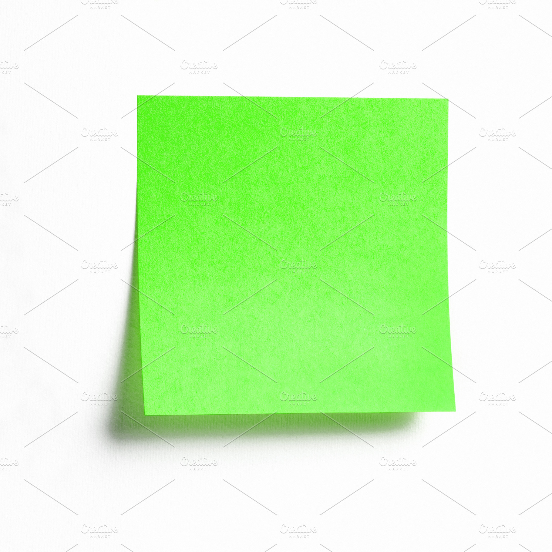 Green sticky note isolated on white, a Business Photo by BOOCYS