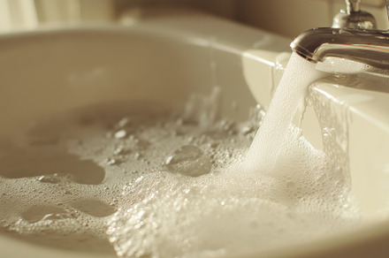 Soapy water flows down a sink in a b, a Photo by Iftikhar Alam