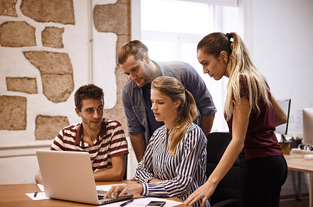 Young business people at work featuring professional, team, and laptop