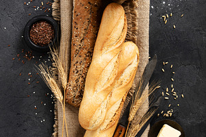 Rustic Baguettes with Flour, Seeds, and Butter on Burlap, a Food & Drink Photo by Natalia Klenova's Shop
