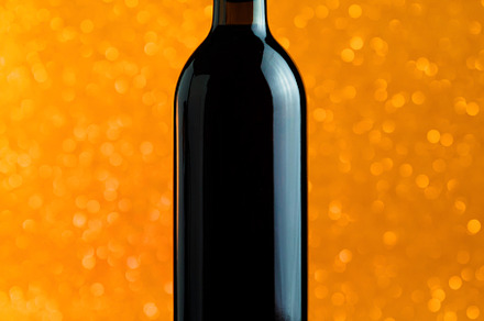 A bottle of wine on a golden bokeh background, a Food & Drink Photo by PavelKant