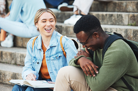 Laughing students, book or studying on stairs on university, school or college campus for test, exam or project. Smile, happy or bonding friends and education learning goals, support or research help, a Photo by Peopleimages.com