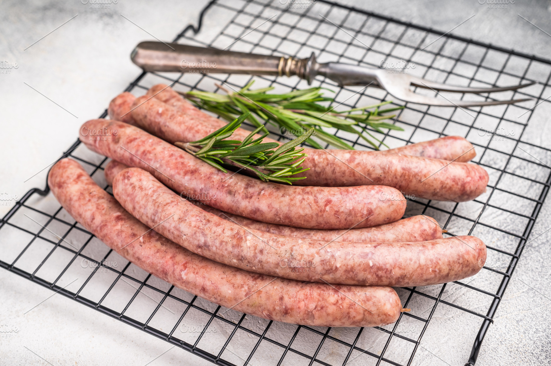 Fresh raw sausage links ready for grilling, perfect for barbecue, a Food & Drink Photo by composter-box@mail.ru