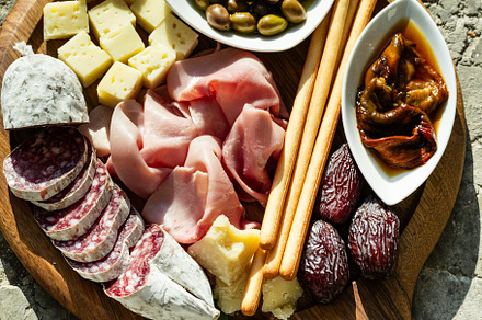 Italian snack and antipasti on a tray and red wine: prosciutto,, a Food & Drink Photo by IriGri