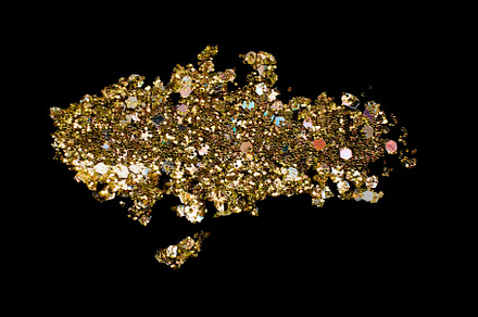 Gold glitter makeup product smear on black. Eye shadow, lip gloss and face for, a Beauty & Fashion Photo by colnihko