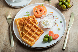 Crunchy waffle fries with sour cream dip served in a basket, a Food & Drink Photo by Budarinphoto