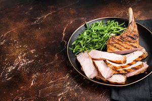 Succulent grilled Tomahawk pork chop, rib bone in steak featurin, a Food & Drink Photo by composter-box@mail.ru