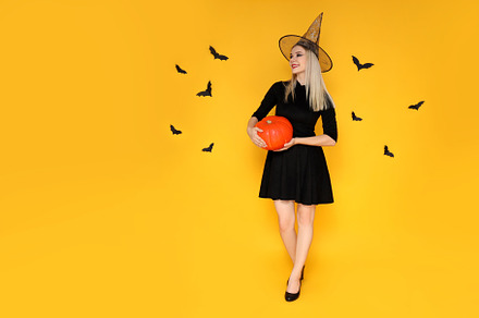 Concept of Halloween, young woman on yellow background, a Person Photo by AtlasStudio PRO