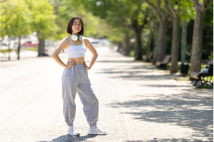 A woman is standing on a sidewalk