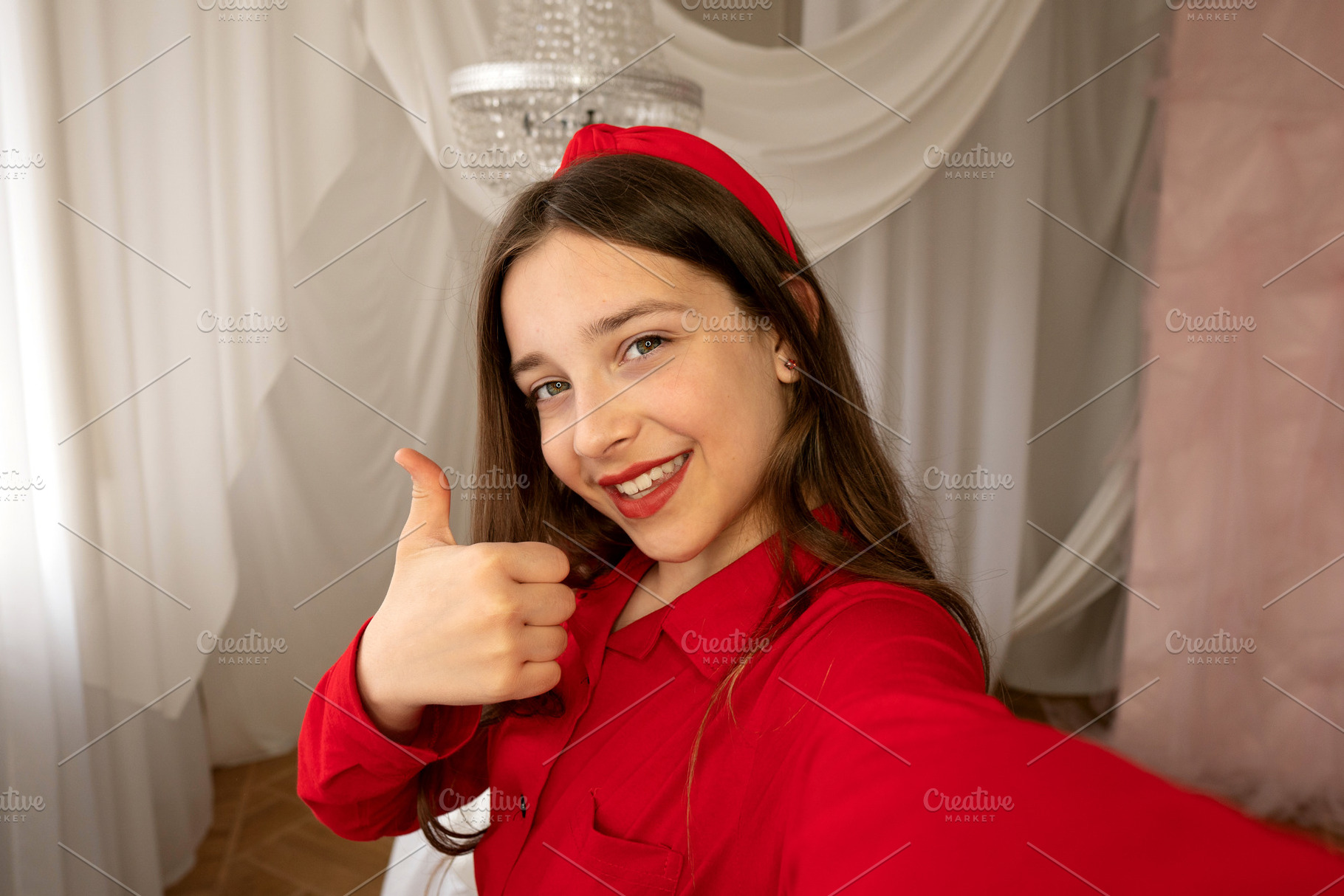 Teen girl smiling giving thumbs-up, a Person Photo by Elena Vagengeim