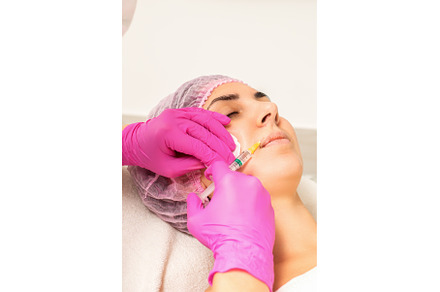 Young caucasian woman getting botox, a Health & Medical Photo by okskukuruza